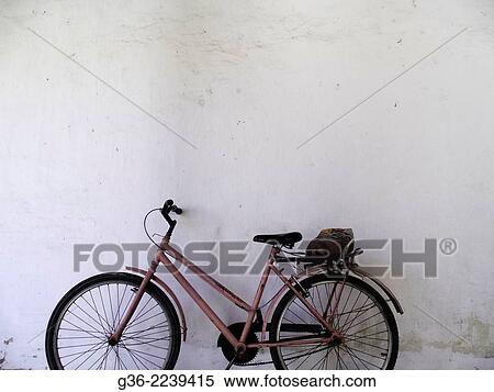 Bicycle parked in front of a wall, Vitoria, Espirito Santo, Brazil. View Large Photo Image Stock Photography - Bicycle parked in front of a wall, Vitoria, Espirito Santo, Brazil.. Fotosearch