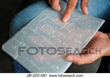 Blind man reading from a page written in braille. View Large Photo Image Stock Photo - Blind man reading from a page written in braille.. Fotosearch