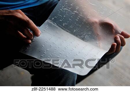 Blind man reading from a page written in braille. View Large Photo Image Stock Photo - Blind man reading from a page written in braille.. Fotosearch