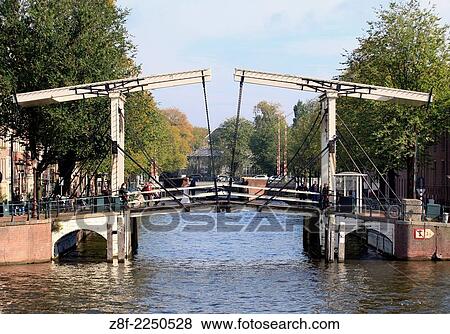 Bridge over canal in Amsterdam, Netherlands. View Large Photo Image Stock Photo - Bridge over canal in Amsterdam, Netherlands.. Fotosearch