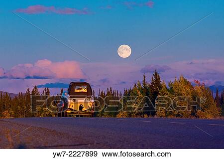 Car on Alaska Highway during full moon, USA. View Large Photo Image Stock Photo - Car on Alaska Highway during full moon, USA.. Fotosearch