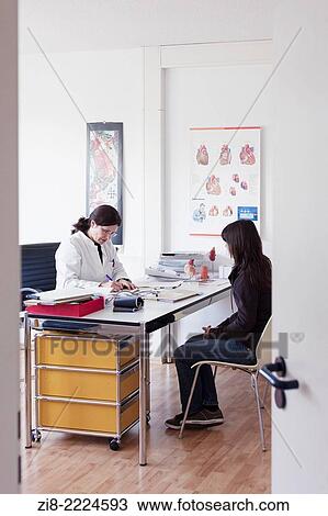 Stock Image - Cardiologist consulting patient.. Fotosearch