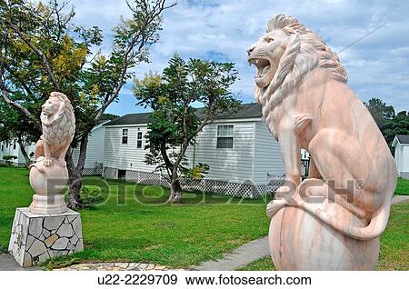 Stock Photo - Chatan, Okinawa, Japan: cheesy lions at the entrance of a residential complex. Fotosearch