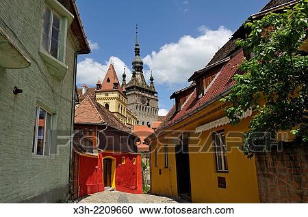 Stock Image - Clock Tower seen from south path leading into Old Town, Sighisoara, Transylvania, Romania, Southeastern and Central Europe.. Fotosearch