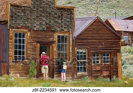 Couple looking through windows of abandoned house in Bodie State Historical Park ghost town; California. #D0406130. View Large Photo Image Stock Image - Couple looking through windows of abandoned house in Bodie State Historical Park ghost town; California. #D0406130.. Fotosearch