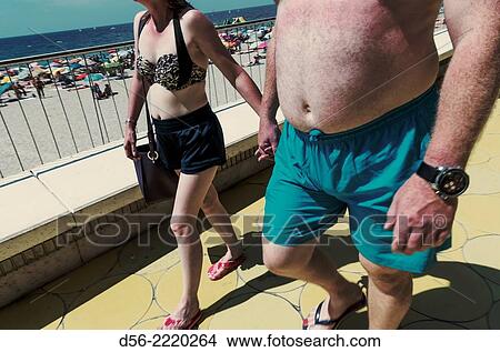 Couple walking, Poniente beach, Benidorm, Alicante province, Spain. View Large Photo Image Picture - Couple walking, Poniente beach, Benidorm, Alicante province, Spain.. Fotosearch
