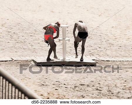 couple washing their feet, Poniente beach, Benidorm, Alicante province. View Large Photo Image Stock Photo - couple washing their feet, Poniente beach, Benidorm, Alicante province.. Fotosearch