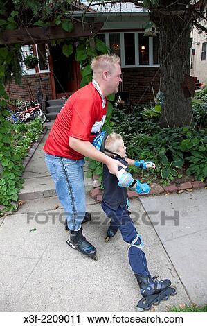 Dad helping his son learn how to rollerblade in front of his home age 35 and 7. St Paul Minnesota MN USA. View Large Photo Image Stock Image - Dad helping his son learn how to rollerblade in front of his home age 35 and 7. St Paul Minnesota MN USA.. Fotosearch