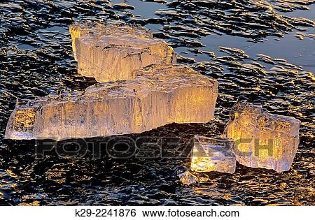 Stock Photograph - Detail of melting late-winter ice along shore of Kelly Lake, Greater Sudbury, Ontario, Canada.. Fotosearch