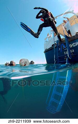Stock Photo - Diver jumps into the water to survey the shipwreck of the Russian transport vessel Bryansk, Odessa, Black Sea, Ukraine, Eastern Europe, Europe.. Fotosearch