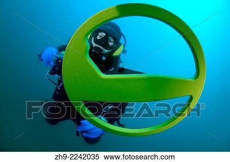Stock Photography - Diver with the metal detector searching for underwater treasure, lake Baikal, Siberia, Russia, Eurasia.. Fotosearch