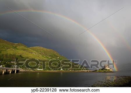 Stock Photo - Eilean Donan Castle with rainbow, near Dornie, Scotland.. Fotosearch