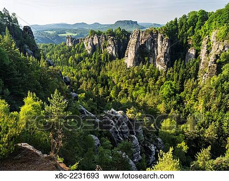 Elbe Sandstone Mountains (Elbsandsteingebirge) in the National Park Saxon Switzerland (Saechsische Schweiz). View towards the Bastei rock formations and valley Wehlgrund. Europe, central europe, germany, saxony, June. View Large Photo Image Stock Image - Elbe Sandstone Mountains (Elbsandsteingebirge) in the National Park Saxon Switzerland (Saechsische Schweiz). View towards the Bastei rock formations and valley Wehlgrund. Europe, central europe, germany, saxony, June.. Fotosearch