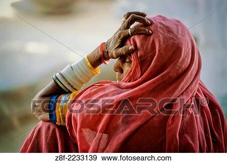 Elderly woman with an expression of weariness wearing a pink headscarf and multiple arm bangles in a village near Jodhpur, India. Digitally Manipulated Image. Stylised by sharpening and enhancing color. View Large Photo Image Stock Photo - Elderly woman with an expression of weariness wearing a pink headscarf and multiple arm bangles in a village near Jodhpur, India. Digitally Manipulated Image. Stylised by sharpening and enhancing color.. Fotosearch