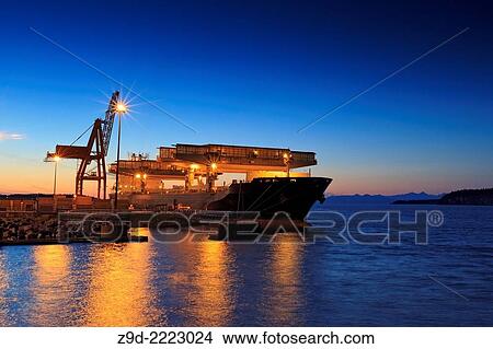 Picture - Freighter being loaded with lumber, Duke Point wharf, Nanaimo, Vancouver Island, British Columbia.. Fotosearch