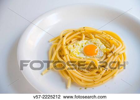 Fried quail egg in a nest made of spaghetti. View Large Photo Image Stock Image - Fried quail egg in a nest made of spaghetti.. Fotosearch