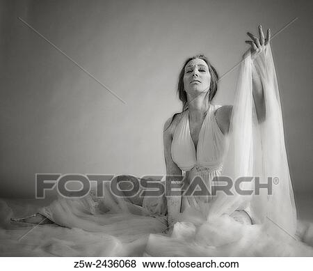 Goddess woman wearing white dress and canvas, tinted black and white image, intentional noise added. View Large Photo Image Stock Photo - Goddess woman wearing white dress and canvas, tinted black and white image, intentional noise added.. Fotosearch