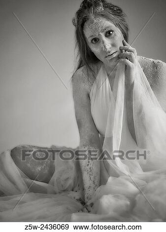 Stock Photo - Goddess woman wearing white dress and canvas, tinted black and white image, intentional noise added.. Fotosearch