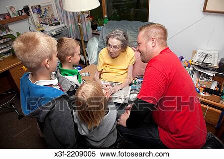 Stock Photography - Grandson and his three children paying visit to their great grandmother. Ages 3, 5, 7, 35 and 96. Battle Lake Minnesota MN USA.. Fotosearch