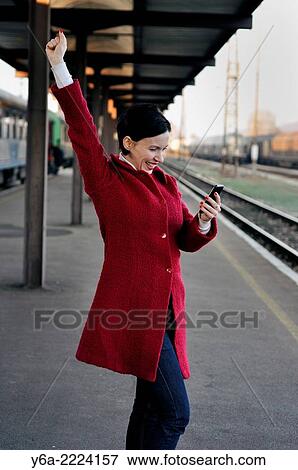 Happy mid adult woman looking at her mobile phone. View Large Photo Image Stock Photo - Happy mid adult woman looking at her mobile phone.. Fotosearch