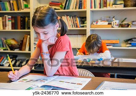 Harrison, New York, USA. Female primary school student working on a class room assignment, while sitting in front of the school´s library. View Large Photo Image Stock Image - Harrison, New York, USA. Female primary school student working on a class room assignment, while sitting in front of the school´s library.. Fotosearch