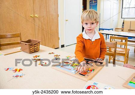 Harrison, New York, USA. Toddler making a class room puzzle at ´t Klokhuis, a school for Dutch language and culture. View Large Photo Image Stock Image - Harrison, New York, USA. Toddler making a class room puzzle at ´t Klokhuis, a school for Dutch language and culture.. Fotosearch