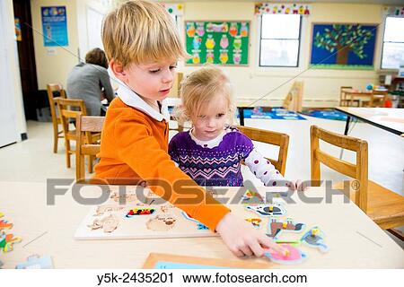 Harrison, New York, USA. Two toddlers making a class room puzzle at ´t Klokhuis, a school for Dutch language and culture. View Large Photo Image Stock Image - Harrison, New York, USA. Two toddlers making a class room puzzle at ´t Klokhuis, a school for Dutch language and culture.. Fotosearch