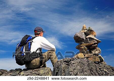 Hiker and rock cairn on trail, Hudson Bay Mountain, Smithers, British Columbia. View Large Photo Image Stock Image - Hiker and rock cairn on trail, Hudson Bay Mountain, Smithers, British Columbia.. Fotosearch