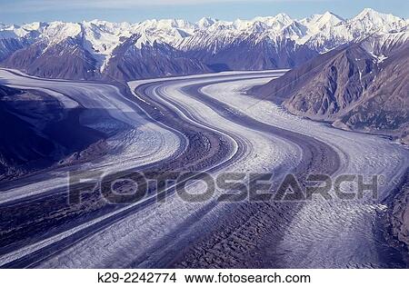 Kaskawulsh glacier and moraines from air (1988), with distant Kluane icefields, Kluane National Park, Yukon, Canada. View Large Photo Image Picture - Kaskawulsh glacier and moraines from air (1988), with distant Kluane icefields, Kluane National Park, Yukon, Canada.. Fotosearch
