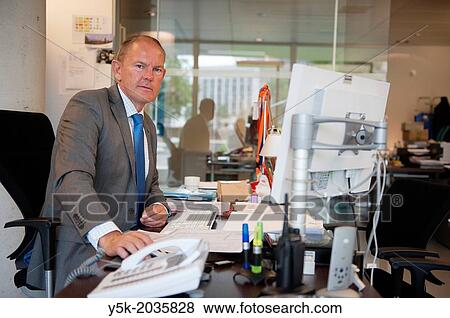Klosterstrasse, East-Berlin, Berlin, Germany. Senior adult male facility manager, working at his desk, supporting the staff of the Dutch embassy. View Large Photo Image Stock Photo - Klosterstrasse, East-Berlin, Berlin, Germany. Senior adult male facility manager, working at his desk, supporting the staff of the Dutch embassy.. Fotosearch