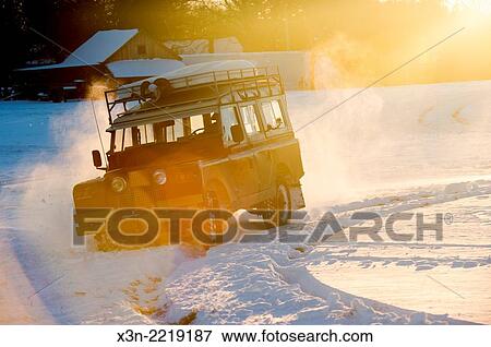 Stock Photo - Land Rover Series 2a driving in snow. Fallston, Maryland, USA.. Fotosearch