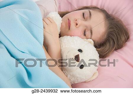 Little girl asleep in bed cuddling her teddy bear View Large Photo Image Stock Image - Little girl asleep in bed cuddling her teddy bear. Fotosearch