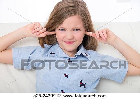 Little girl refusing to hear and stopping noise by putting her fingers in her ears View Large Photo Image Stock Image - Little girl refusing to hear and stopping noise by putting her fingers in her ears. Fotosearch