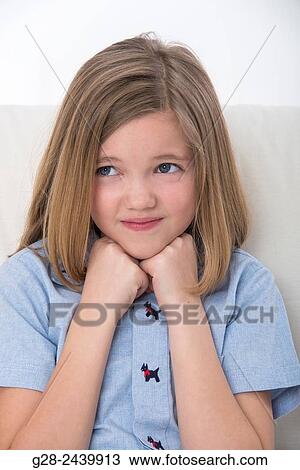 little girl smiling and resting her head on her hands with a mischievous smile, concept for a stubborn attitude View Large Photo Image Stock Image - little girl smiling and resting her head on her hands with a mischievous smile, concept for a stubborn attitude. Fotosearch