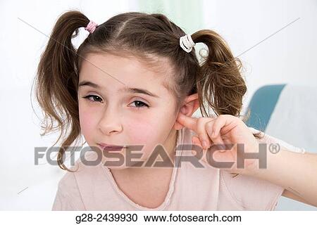 Little girl with bunches stopping her ear with her finger sitting on a medical couch View Large Photo Image Stock Image - Little girl with bunches stopping her ear with her finger sitting on a medical couch. Fotosearch