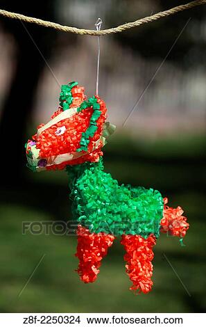 Picture - Made by artesans with papier mache, Pinatas have sweets inside and children breake them with a sitck. Use in birthdays and the days before chrismas. The points represented the seven deadly sins, and the bright colors of the pinata symbolize temptation.. Fotosearch