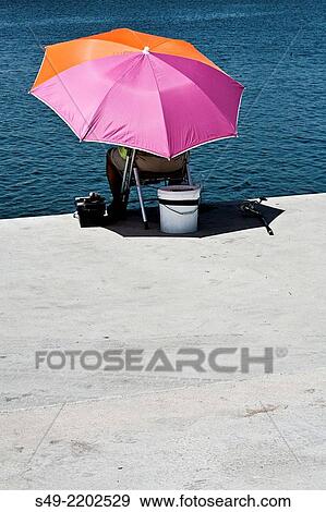 Man fishing in a riverbank, Valencia, Spain. View Large Photo Image Stock Photo - Man fishing in a riverbank, Valencia, Spain.. Fotosearch