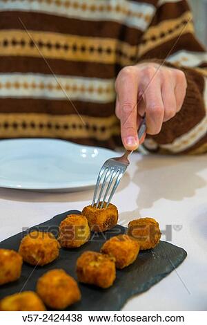 Man´s hand having croquettes. Close view. View Large Photo Image Stock Photo - Man´s hand having croquettes. Close view.. Fotosearch