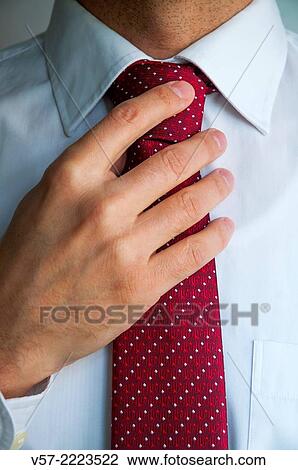 Man tying his tie. Close view. View Large Photo Image Stock Image - Man tying his tie. Close view.. Fotosearch