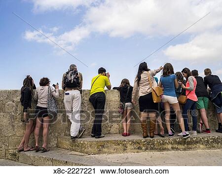 Mdina old town, tourists looking over the city walls, Mdina is the old capital of Malta. Europe, Southern Europe, Malta, April. View Large Photo Image Stock Image - Mdina old town, tourists looking over the city walls, Mdina is the old capital of Malta. Europe, Southern Europe, Malta, April.. Fotosearch