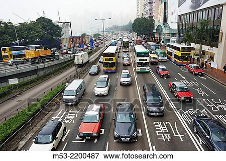 Stock Photo - Morning traffic of public buses, taxis, commercial and private vehicles moving in west direction along Gloucester Road. Wan Chai District. Hong Kong. China.. Fotosearch