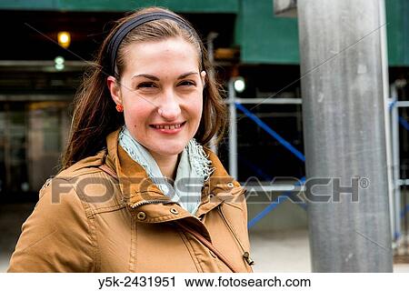 New York, USA. Attractive, young brunette filling out a model release, while sitting at a table, down town Manhattan. View Large Photo Image Stock Image - New York, USA. Attractive, young brunette filling out a model release, while sitting at a table, down town Manhattan.. Fotosearch