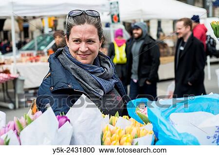 New York, USA. Dark blonde woman buying flowers at a market stall on Union Square, Manhattan. View Large Photo Image Stock Image - New York, USA. Dark blonde woman buying flowers at a market stall on Union Square, Manhattan.. Fotosearch