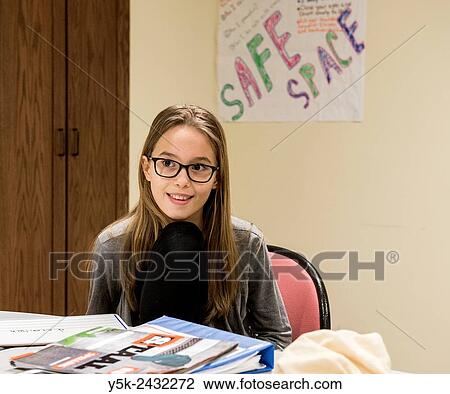 Stock Image - New York, USA. Female primary school student at ´t Klokhuis, a school for Dutch language and culture, during a class room assignment.. Fotosearch
