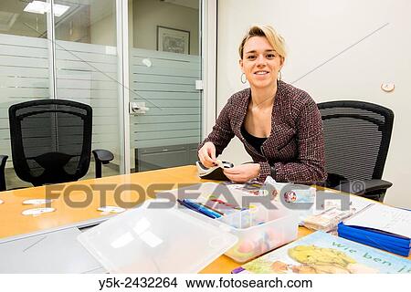New York, USA. Female teacher at ´t Klokhuis, a school for Dutch language and culture, behind her classroom table. View Large Photo Image Picture - New York, USA. Female teacher at ´t Klokhuis, a school for Dutch language and culture, behind her classroom table.. Fotosearch