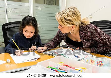 New York, USA. Female teacher at ´t Klokhuis, a school for Dutch language and culture, teaching a young student Dutch idiom. View Large Photo Image Stock Image - New York, USA. Female teacher at ´t Klokhuis, a school for Dutch language and culture, teaching a young student Dutch idiom.. Fotosearch