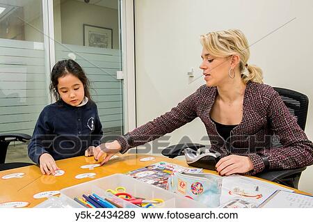 New York, USA. Female teacher at ´t Klokhuis, a school for Dutch language and culture, teaching a young student Dutch idiom. View Large Photo Image Stock Photo - New York, USA. Female teacher at ´t Klokhuis, a school for Dutch language and culture, teaching a young student Dutch idiom.. Fotosearch