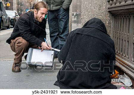 New York, USA, Male social workers with Goddard Riverside, reaching out to a homeless person, living in the streets of Manhattan. View Large Photo Image Stock Image - New York, USA, Male social workers with Goddard Riverside, reaching out to a homeless person, living in the streets of Manhattan.. Fotosearch
