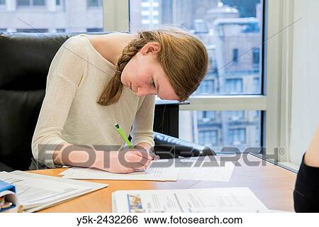 New York, USA. One female student at ´t Klokhuis, a school for Dutch language and culture, working on a class room assignment. View Large Photo Image Stock Photograph - New York, USA. One female student at ´t Klokhuis, a school for Dutch language and culture, working on a class room assignment.. Fotosearch