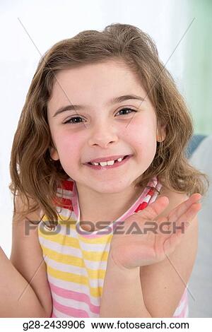 Stock Photograph - Over active Smiling little girl with missing tooth. Fotosearch